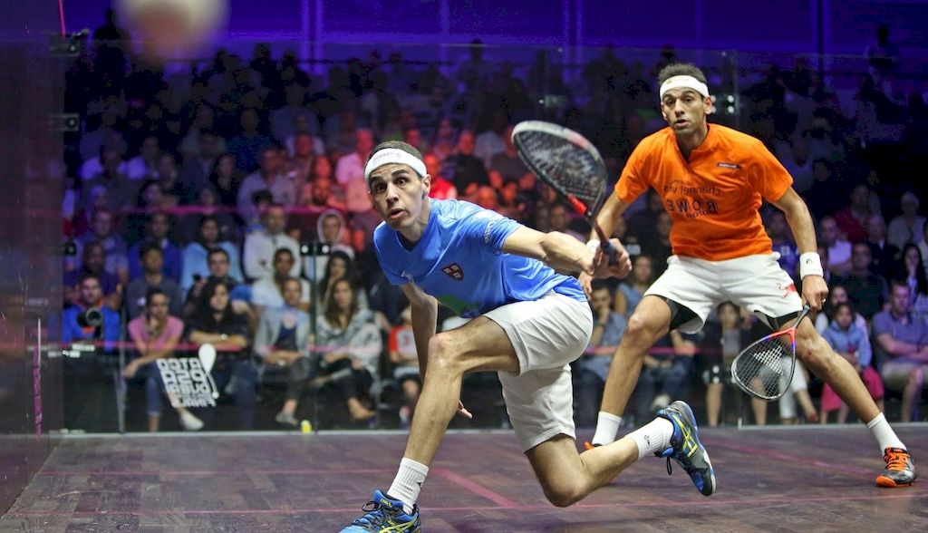 squash player kicks the ball